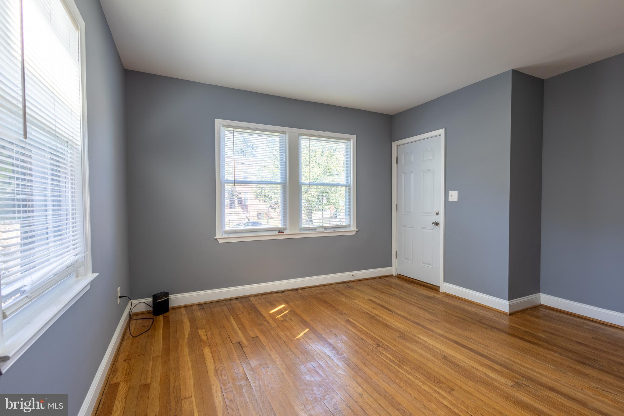 2204 16th Street Southeast, Unit 2 Washington, DC 20020 - Photo 7 of 11 an empty room with wooden floor and windows