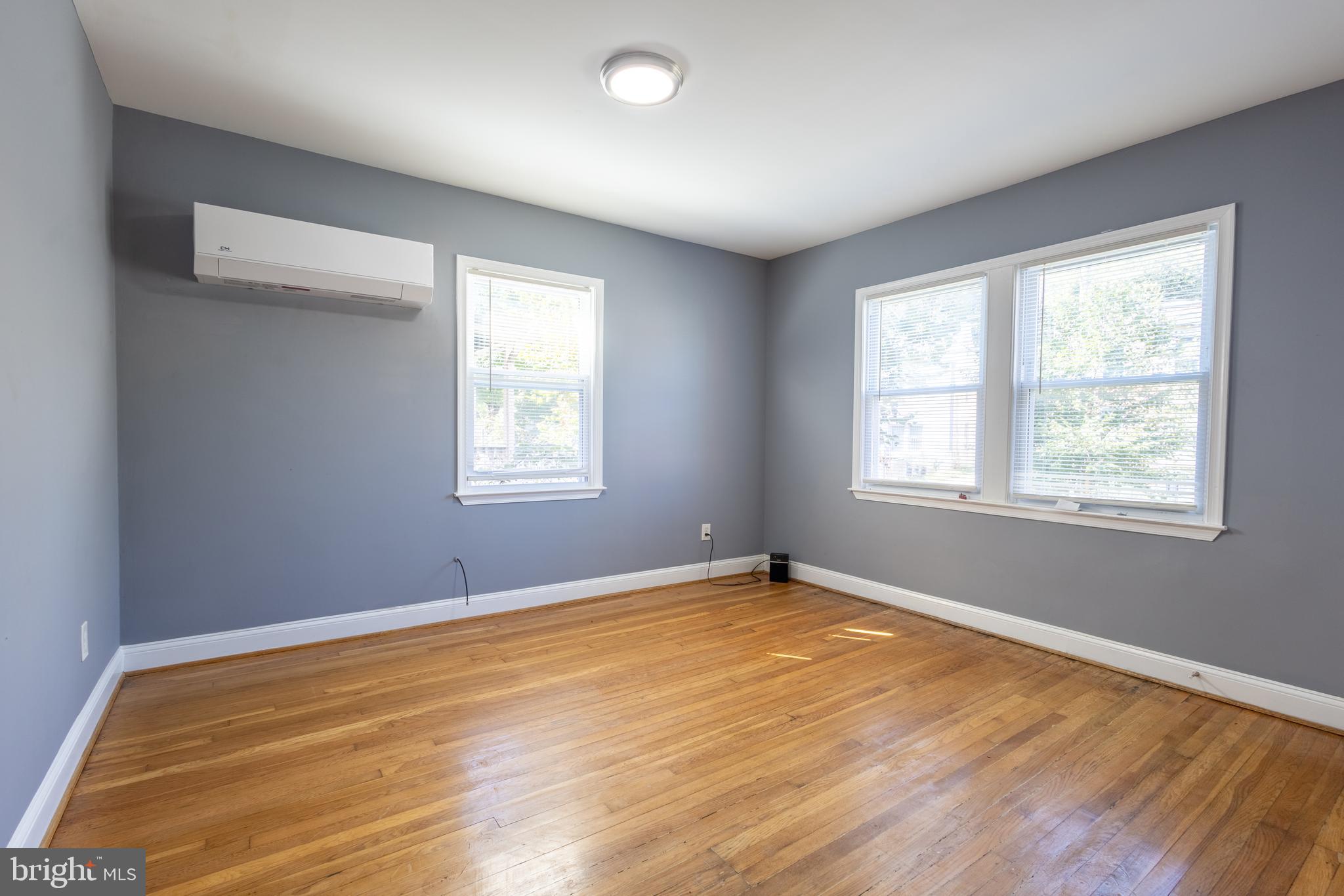2204 16th Street Southeast, Unit 2 Washington, DC 20020 - Photo 8 of 11 a view of an empty room with wooden floor and a window