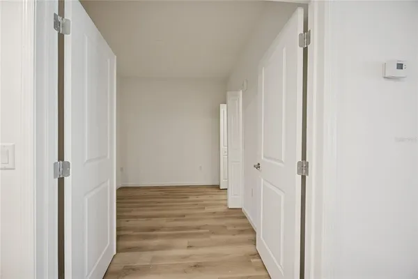 a view of a hallway with wooden floor