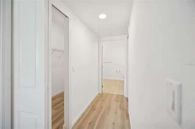 a view of a room with wooden floor