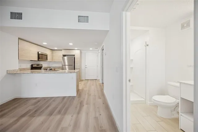 a view of kitchen with wooden floor