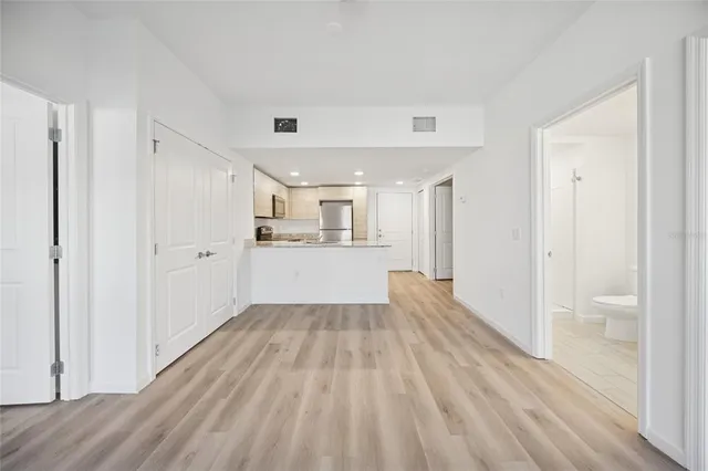 a view of a kitchen with wooden floor and a sink