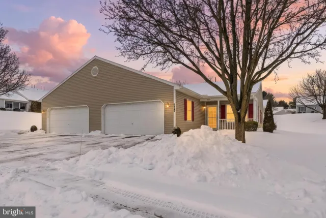 a view of a house with a snow in the yard