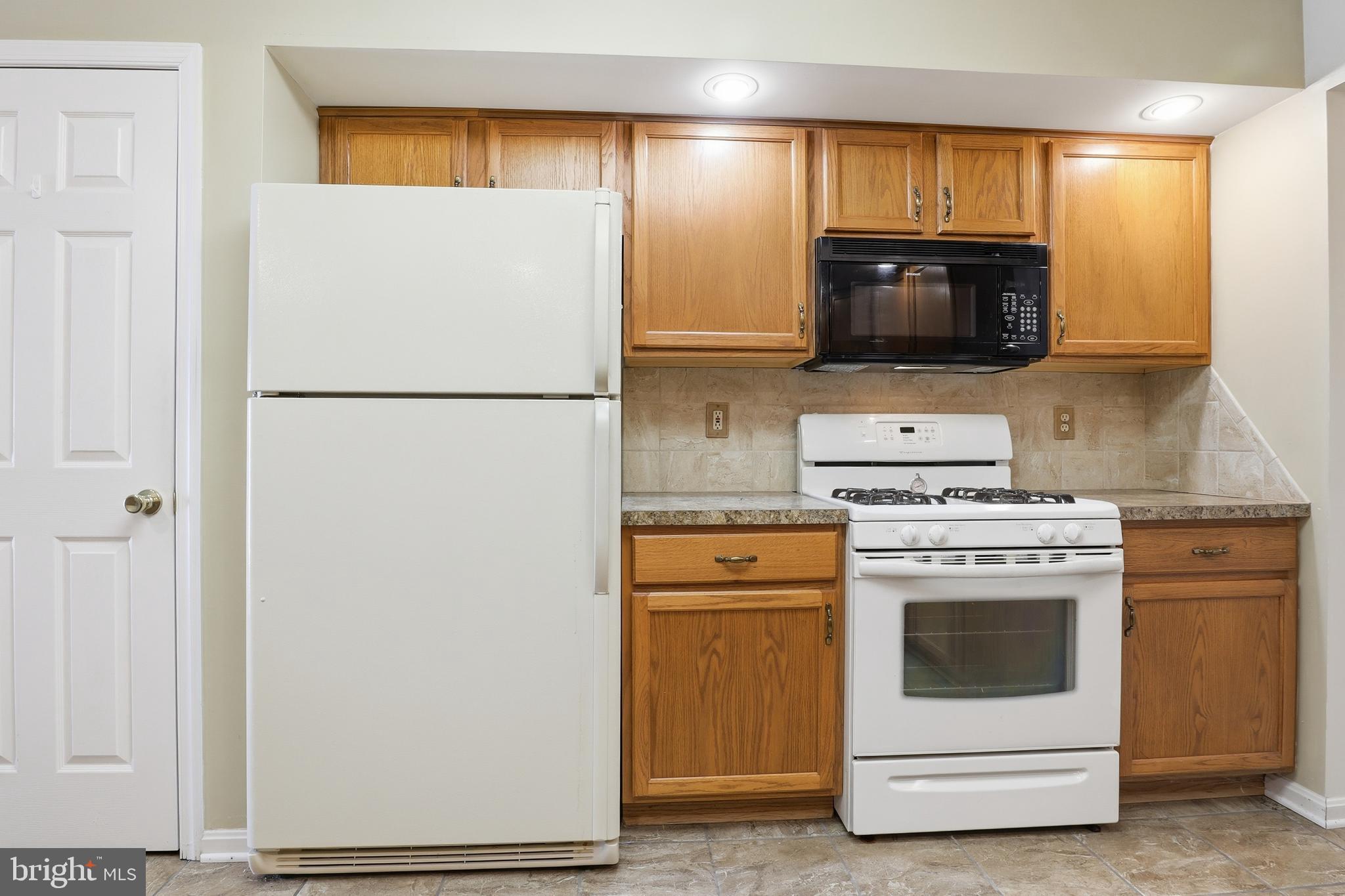 3004 Lakefield Road, Unit 3004 York, PA 17402 - Photo 12 of 33 a kitchen with a stove microwave and refrigerator