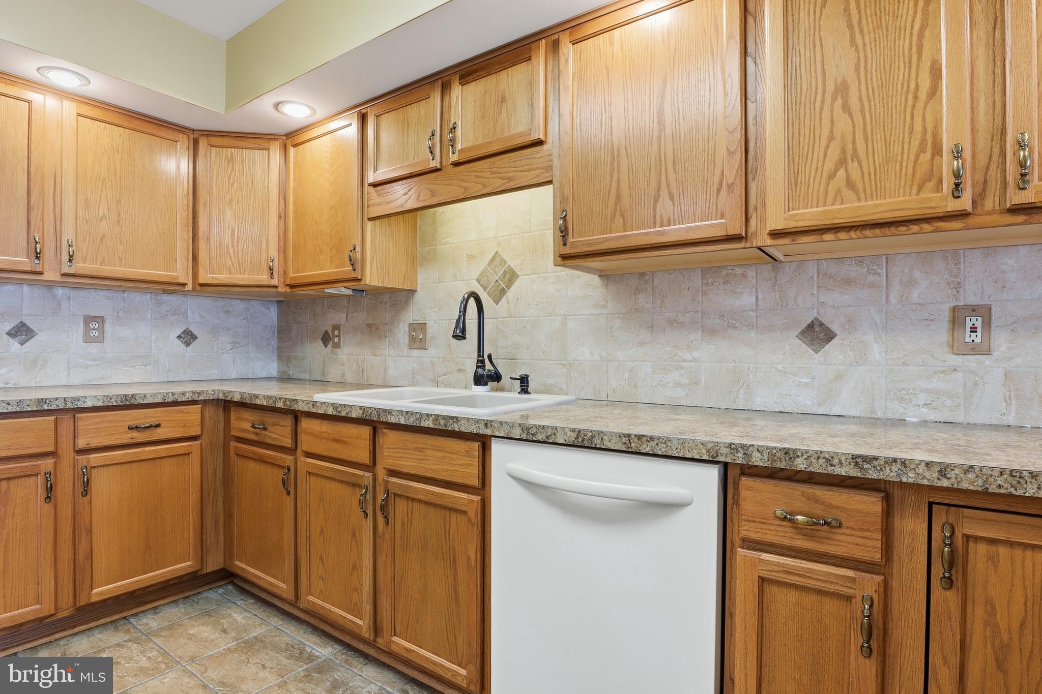 3004 Lakefield Road, Unit 3004 York, PA 17402 - Photo 13 of 33 a kitchen with stainless steel appliances granite countertop a sink and cabinets with wooden floor