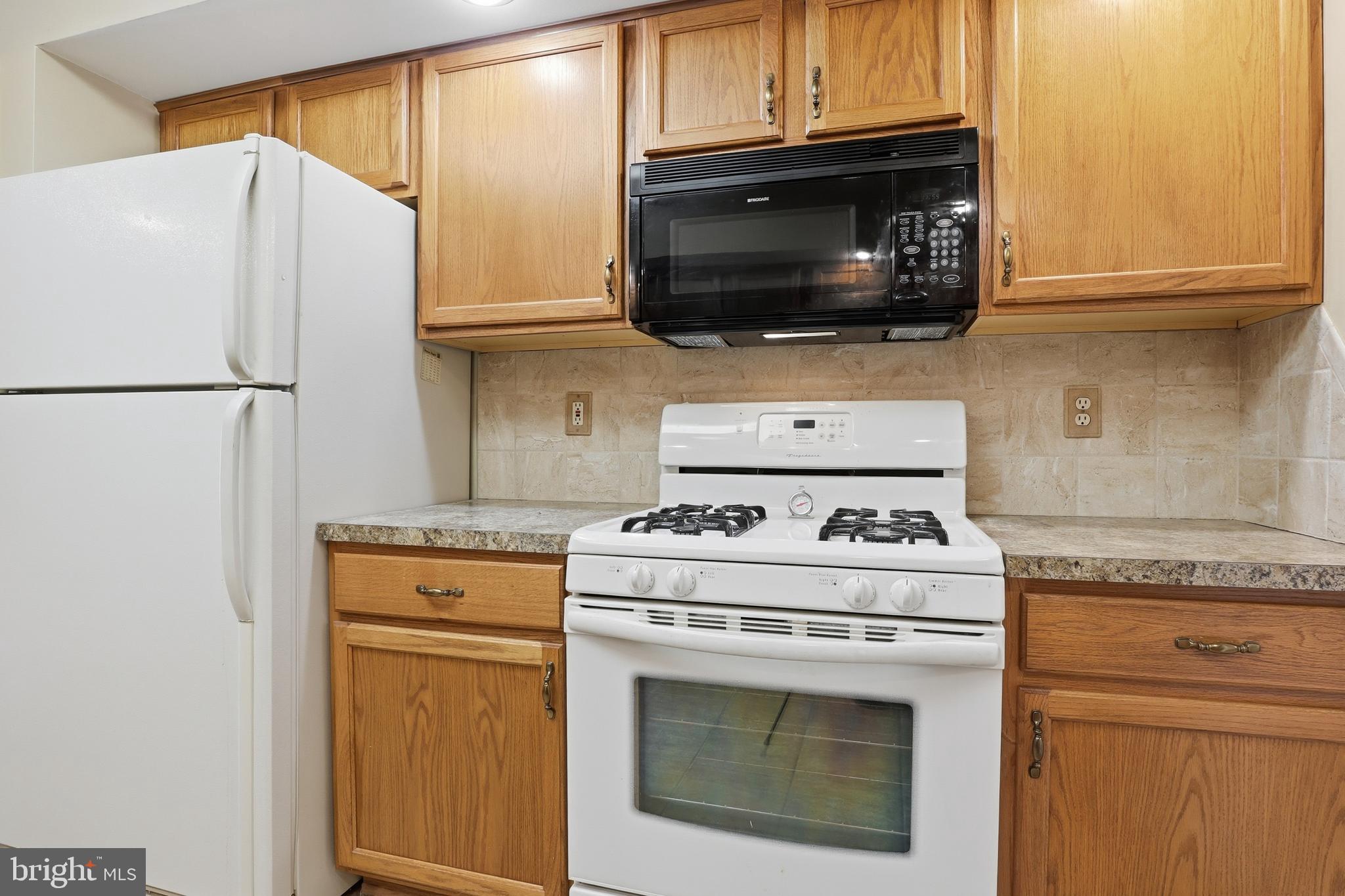 3004 Lakefield Road, Unit 3004 York, PA 17402 - Photo 14 of 33 a kitchen with a stove microwave and refrigerator