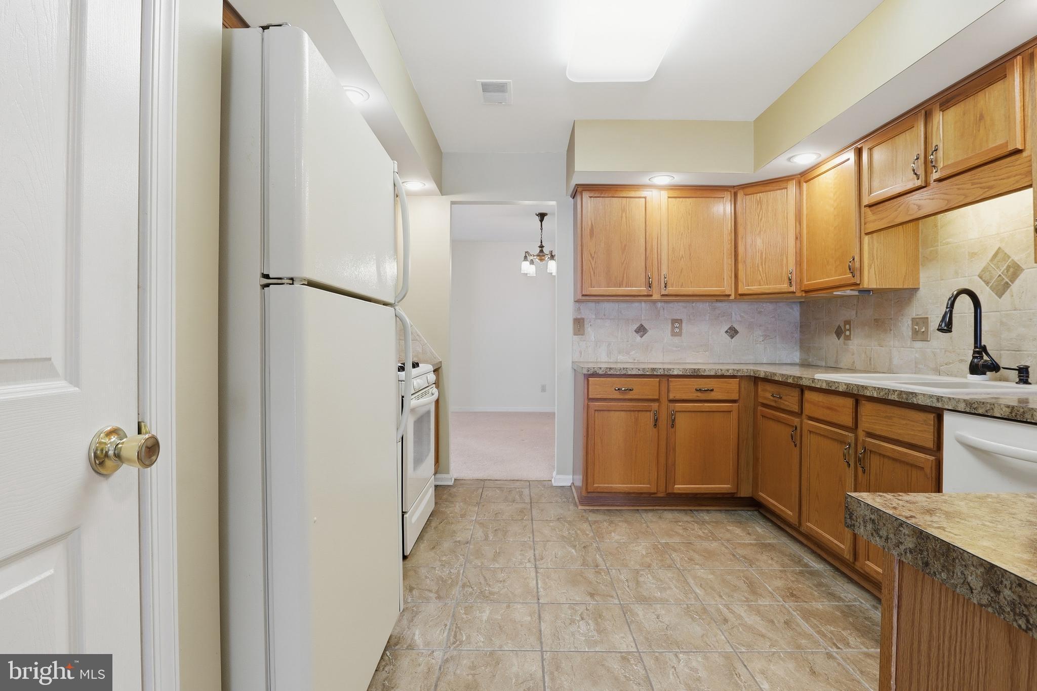 3004 Lakefield Road, Unit 3004 York, PA 17402 - Photo 15 of 33 a kitchen with a sink refrigerator and cabinets