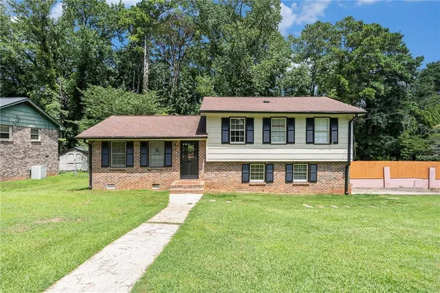 a front view of a house with a yard table and chairs