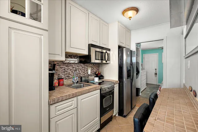 a kitchen with a refrigerator and a sink