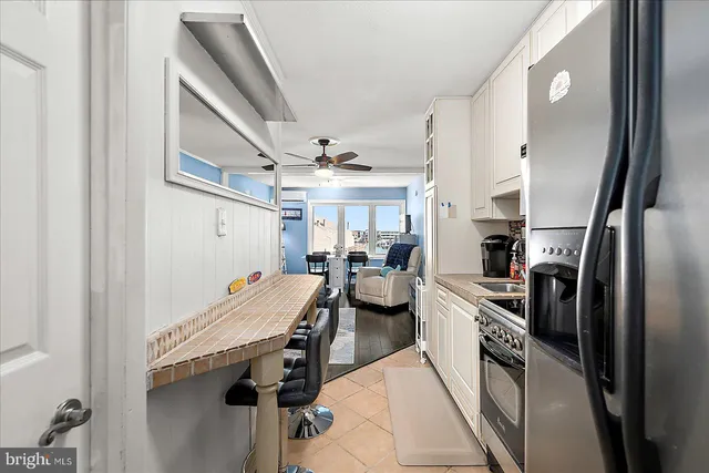 a kitchen with a sink appliances and cabinets