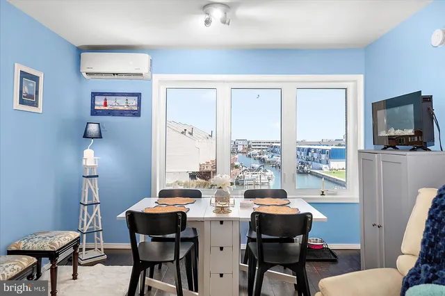 a view of a dining room with furniture and a potted plant