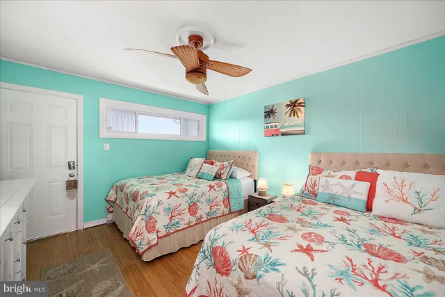 a bedroom with two beds and painted walls