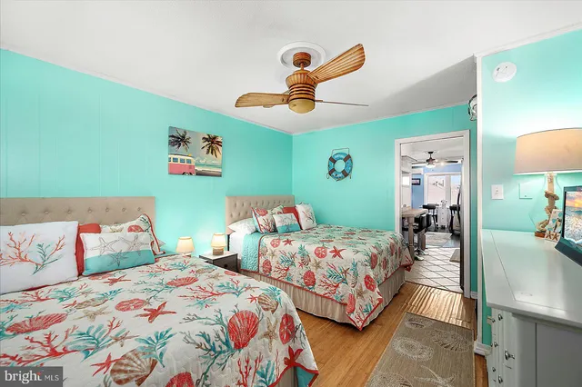 a bedroom with two beds and painted walls