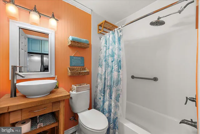 a bathroom with a granite countertop toilet a sink and a shower
