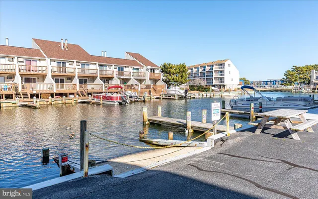 a view of swimming pool with outdoor seating and lake view