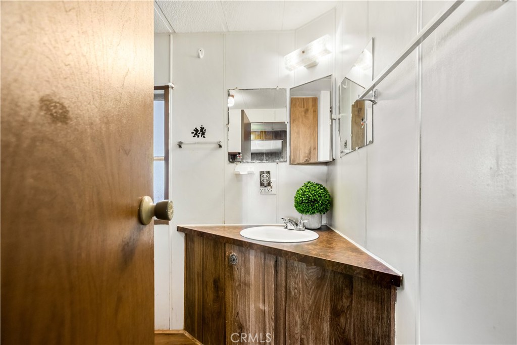 3745 Valley Boulevard, Unit 50 Walnut, CA 91789 - Photo 17 of 32 a bathroom with a sink and mirror