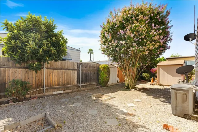 a backyard of a house with a tree