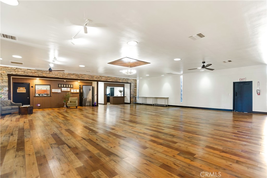 3745 Valley Boulevard, Unit 50 Walnut, CA 91789 - Photo 24 of 32 an empty room with wooden floor and chandelier