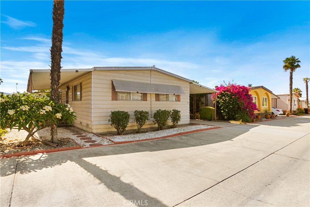 3745 Valley Boulevard, Unit 50 Walnut, CA 91789 - Photo 3 of 32 a front view of a house with a yard