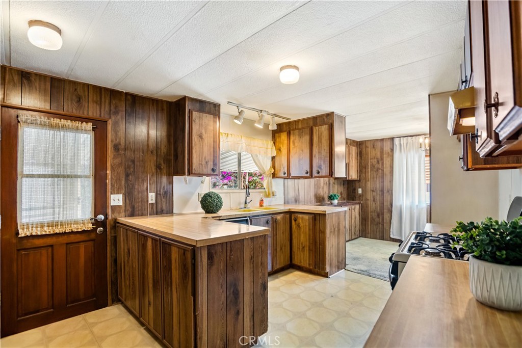3745 Valley Boulevard, Unit 50 Walnut, CA 91789 - Photo 6 of 32 a kitchen with a sink stove and cabinets