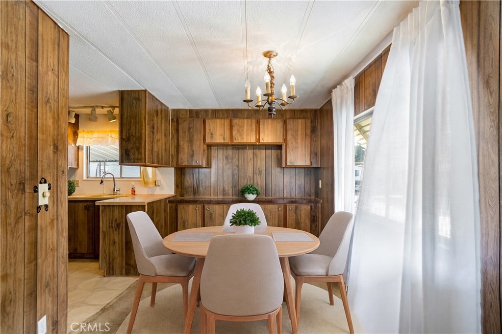 3745 Valley Boulevard, Unit 50 Walnut, CA 91789 - Photo 7 of 32 a view of a dining room with furniture a chandelier and wooden floor