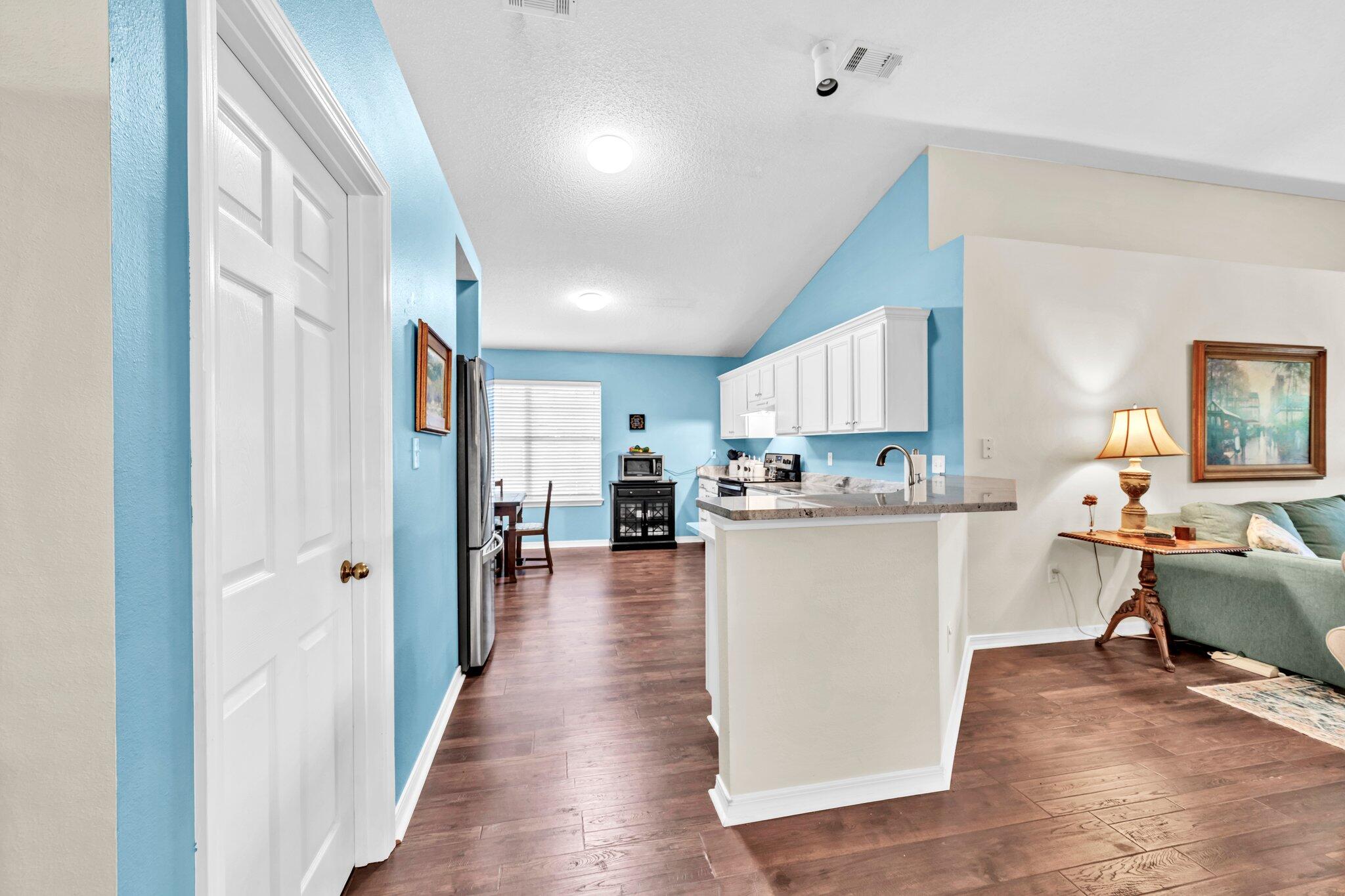 174 Bayou Landing Road Miramar Beach, FL 32550 - Photo 11 of 42 a view of a kitchen with kitchen island stainless steel appliances refrigerator stove microwave and cabinets