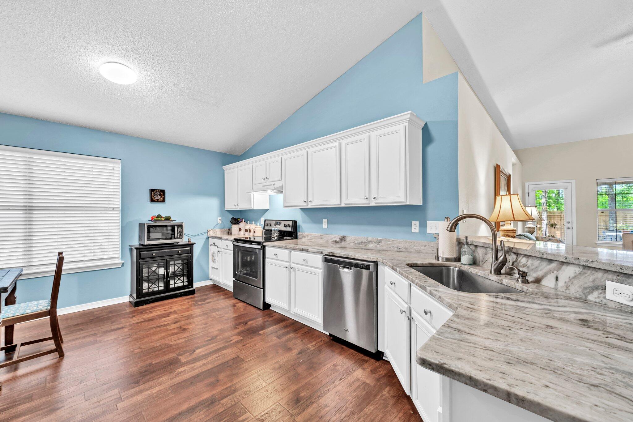 174 Bayou Landing Road Miramar Beach, FL 32550 - Photo 13 of 42 a kitchen with kitchen island granite countertop a stove top oven a sink a counter space and cabinets