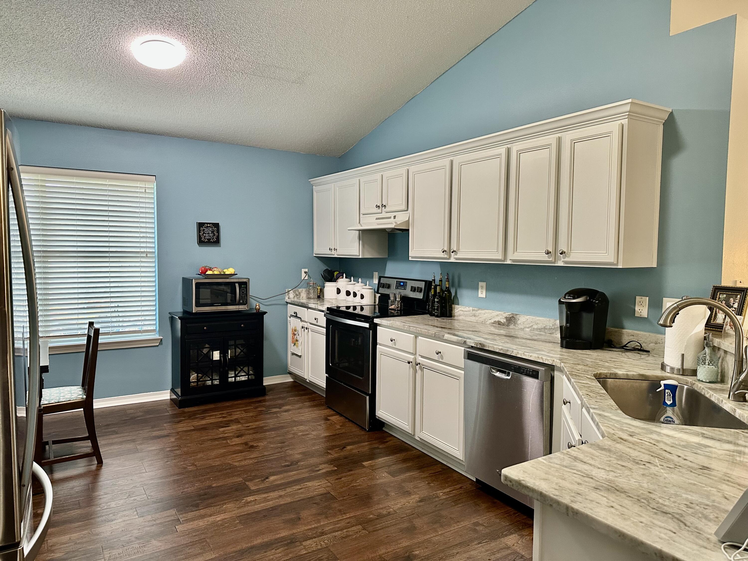 174 Bayou Landing Road Miramar Beach, FL 32550 - Photo 16 of 42 a kitchen with granite countertop a stove top oven sink and cabinets