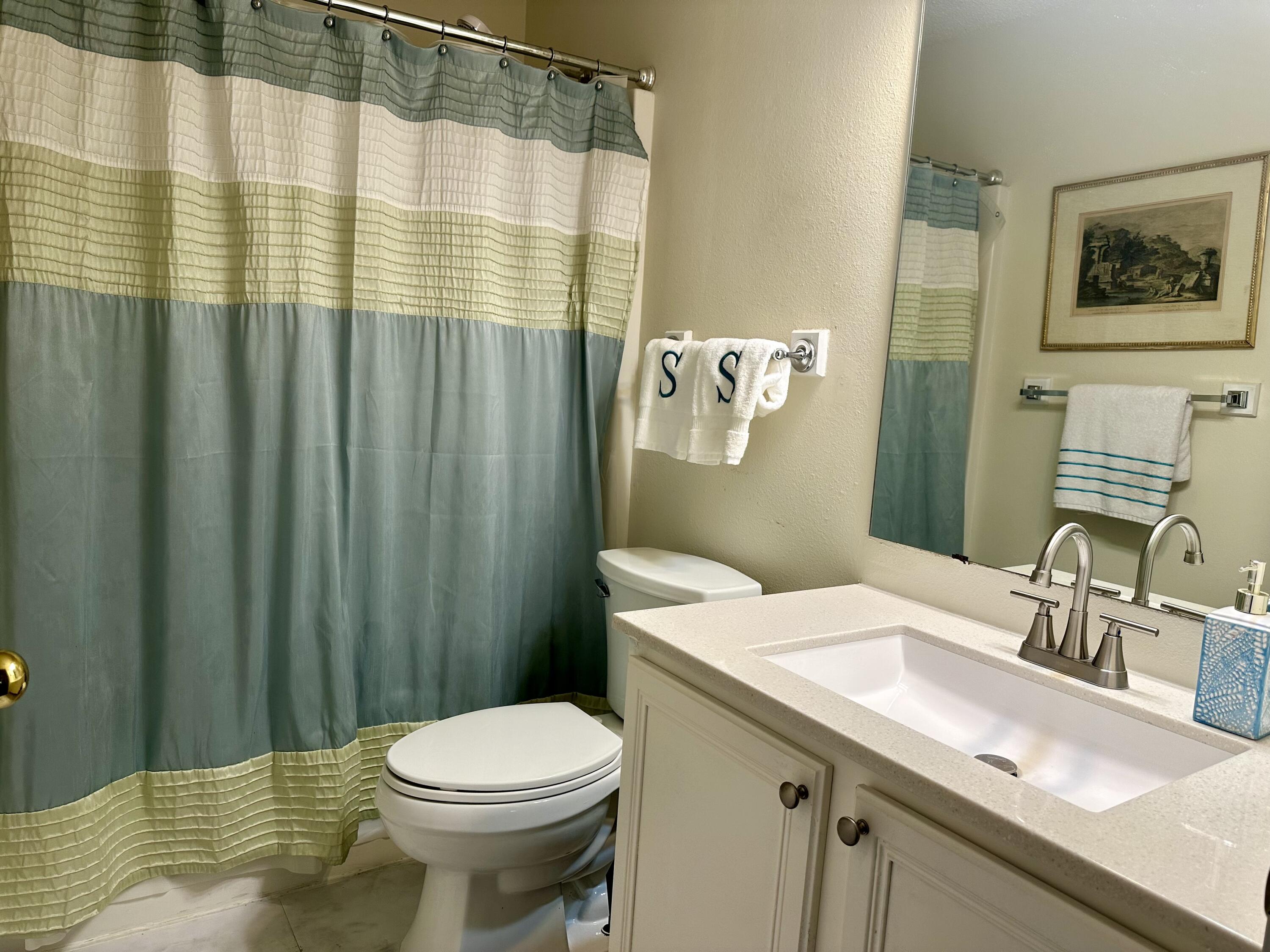 174 Bayou Landing Road Miramar Beach, FL 32550 - Photo 20 of 42 a bathroom with a sink a toilet and shower curtain