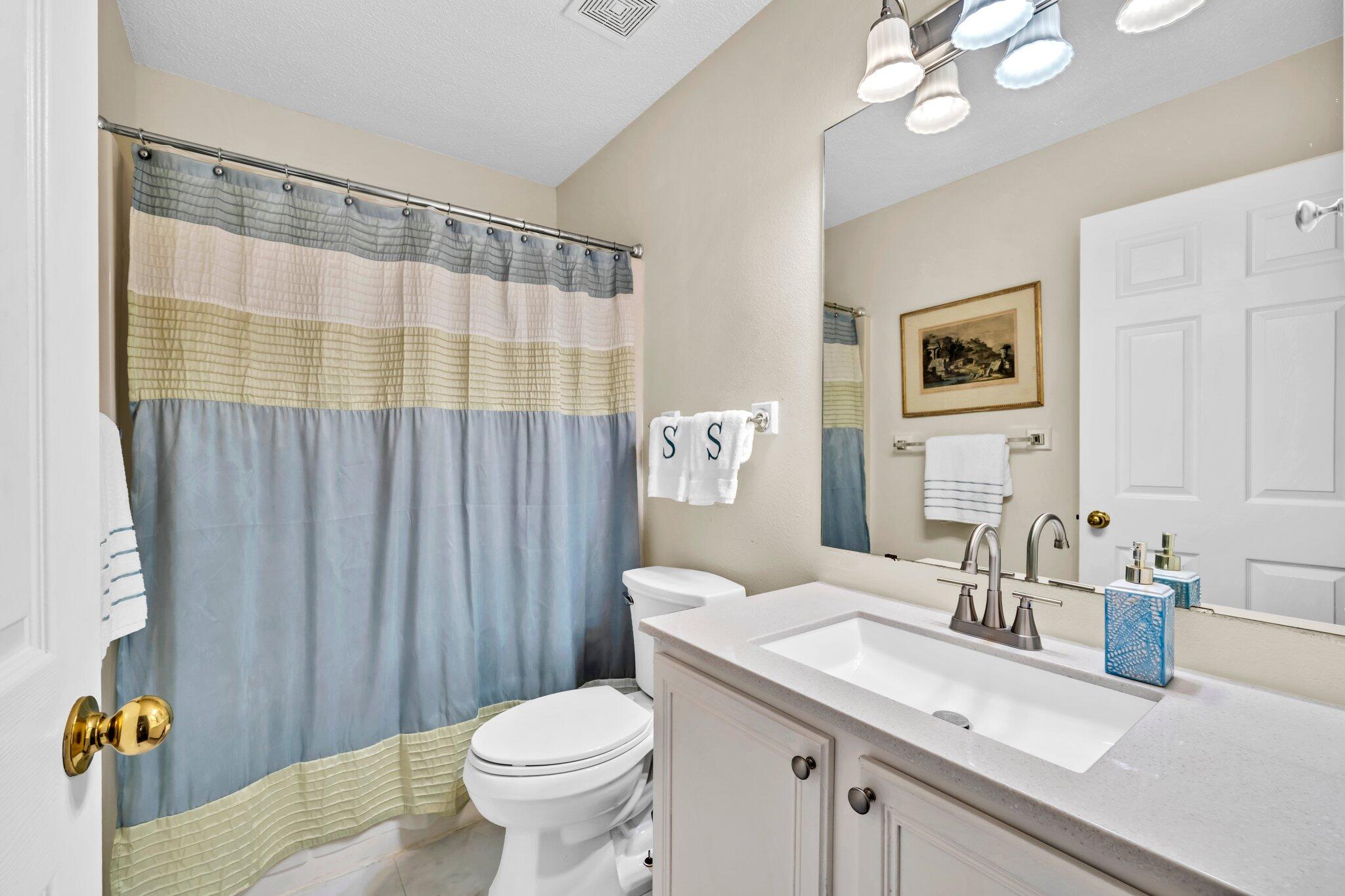 174 Bayou Landing Road Miramar Beach, FL 32550 - Photo 21 of 42 a bathroom with a sink a toilet and shower curtain