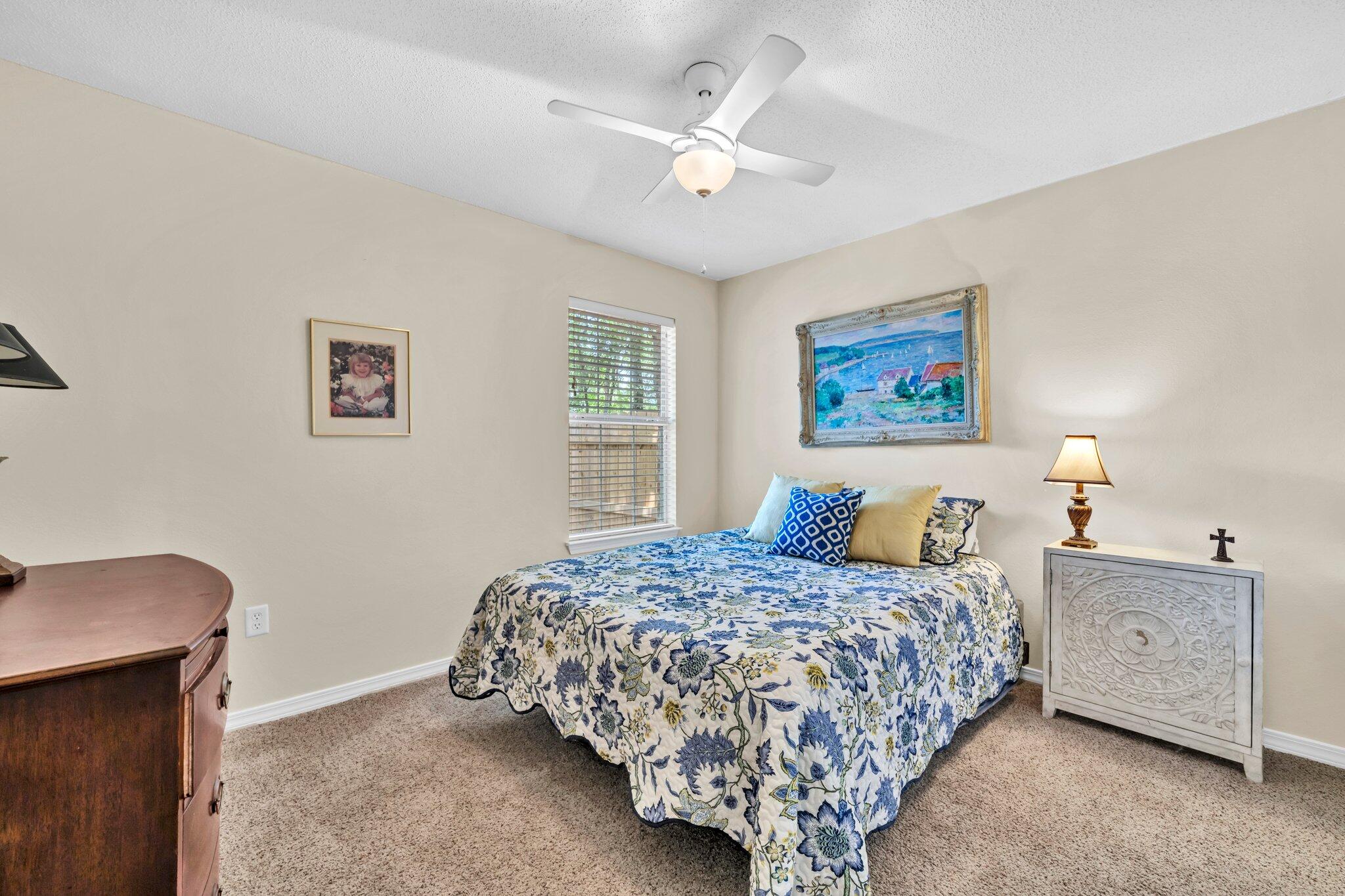 174 Bayou Landing Road Miramar Beach, FL 32550 - Photo 22 of 42 a bedroom with a large bed and a chandelier