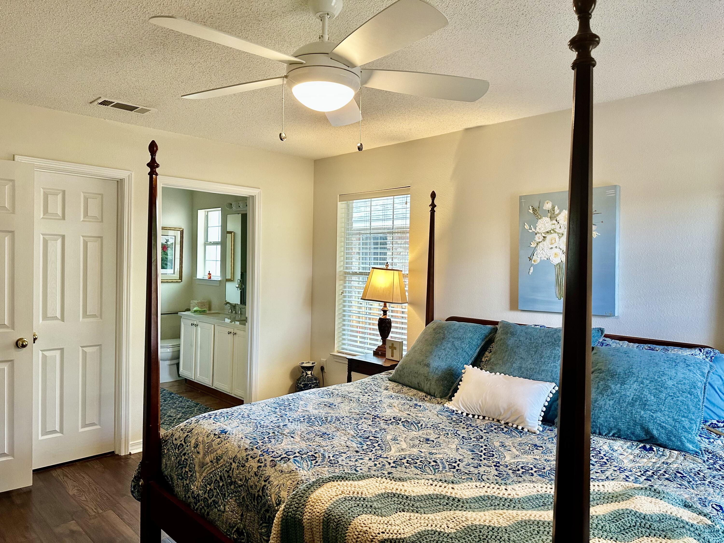 174 Bayou Landing Road Miramar Beach, FL 32550 - Photo 24 of 42 a bedroom with a bed and a chandelier