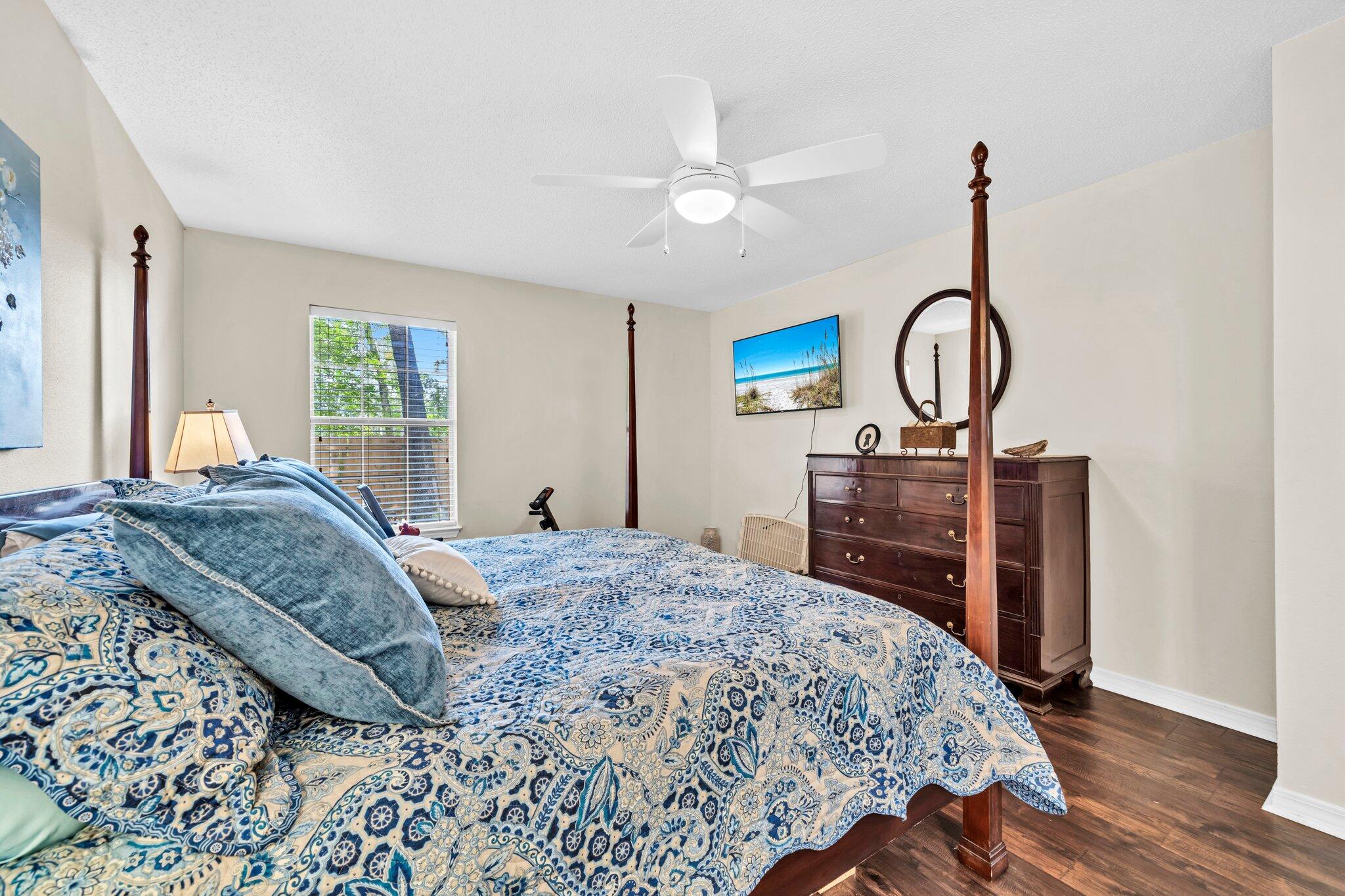 174 Bayou Landing Road Miramar Beach, FL 32550 - Photo 26 of 42 a bedroom with a bed a chandelier and dresser
