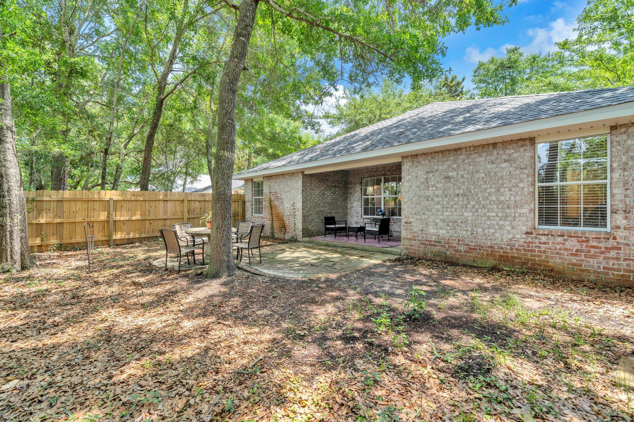 174 Bayou Landing Road Miramar Beach, FL 32550 - Photo 30 of 42 a view of a yard with a house and a large tree