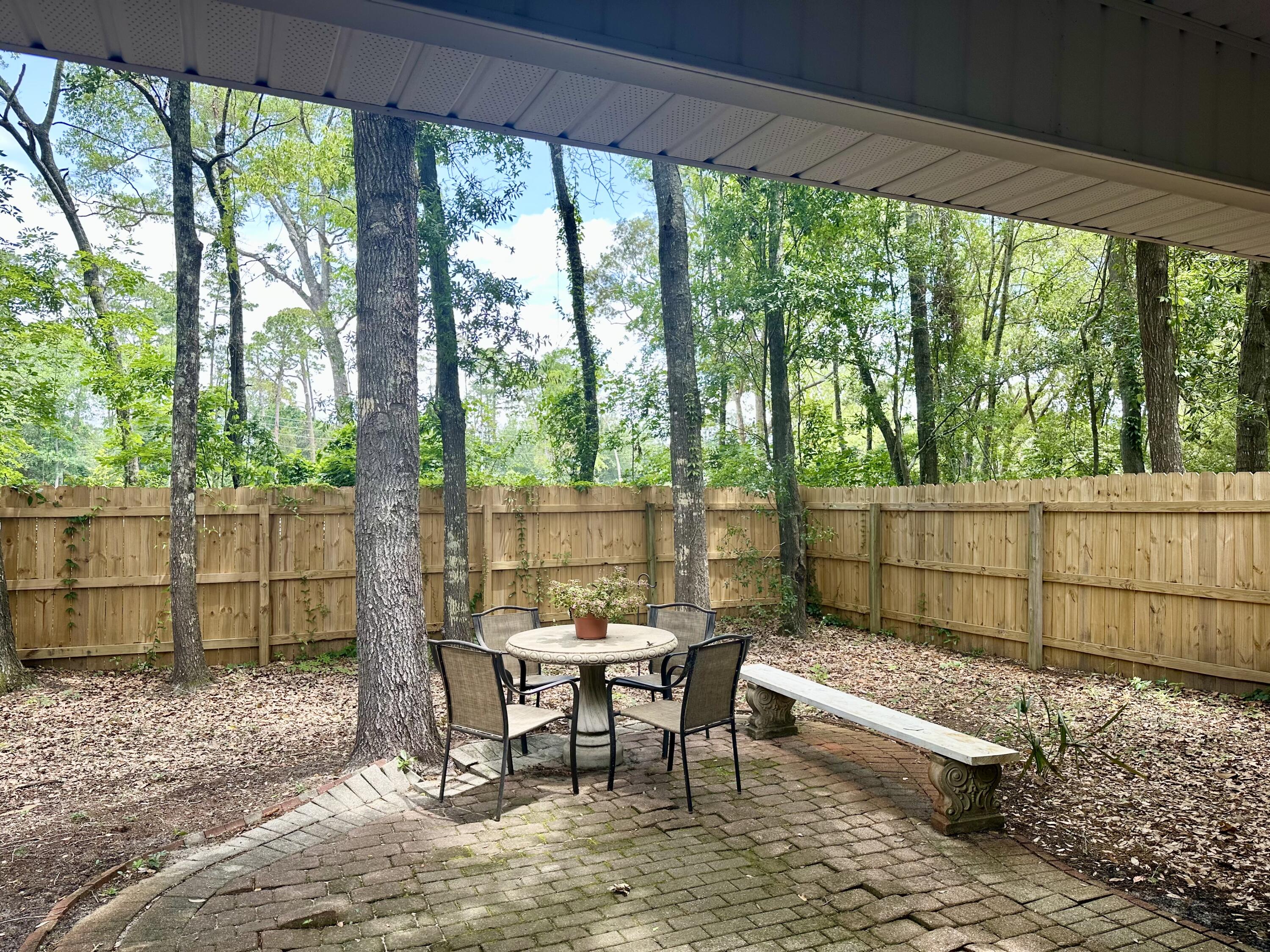 174 Bayou Landing Road Miramar Beach, FL 32550 - Photo 31 of 42 a view of a yard with furniture and wooden fence