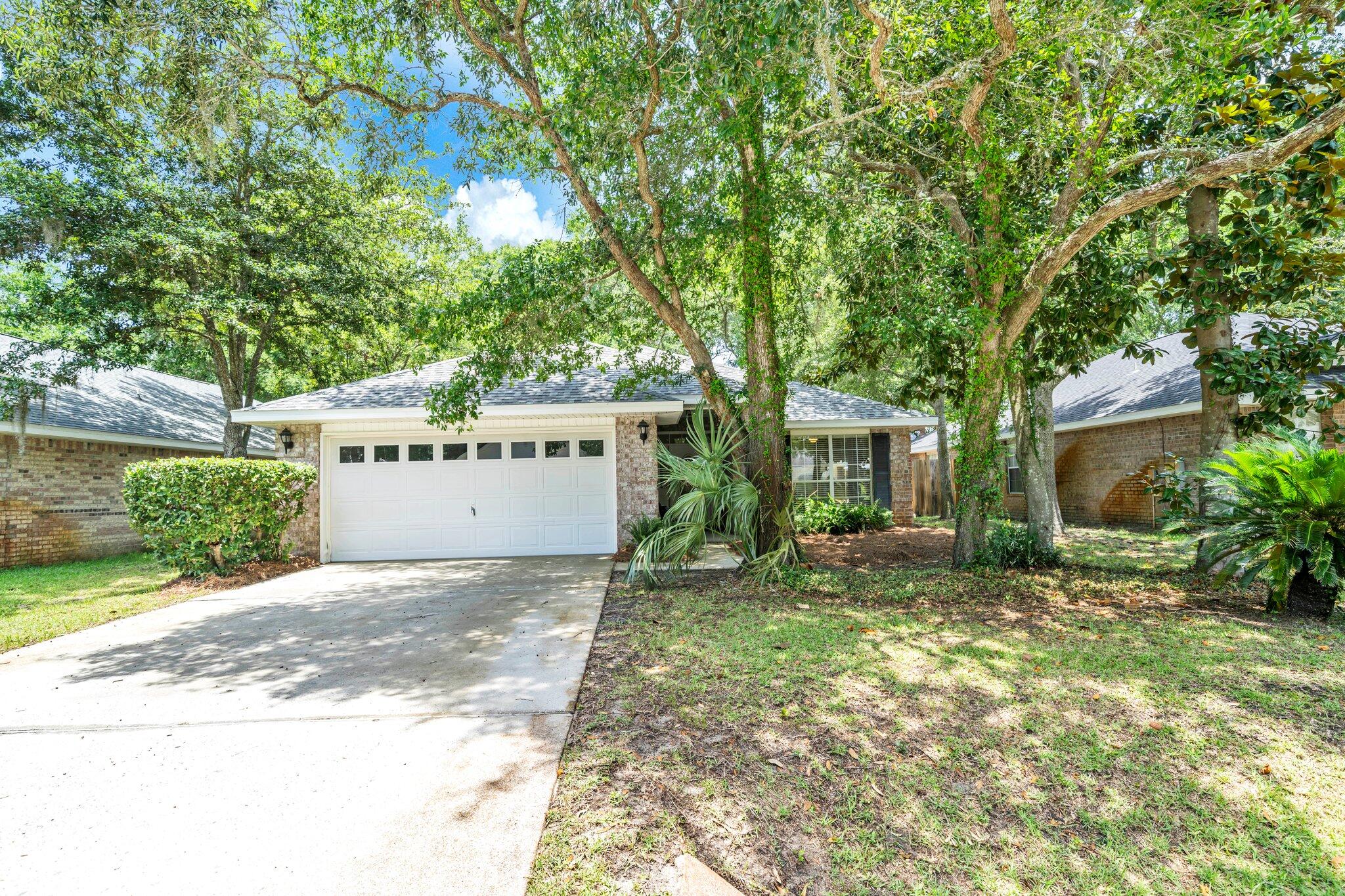 174 Bayou Landing Road Miramar Beach, FL 32550 - Photo 38 of 42 a view of a house with a yard and potted plants