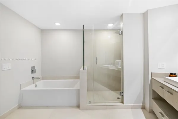 a bathroom with a granite countertop sink a toilet and shower