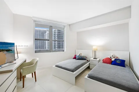 a bedroom with furniture and a window