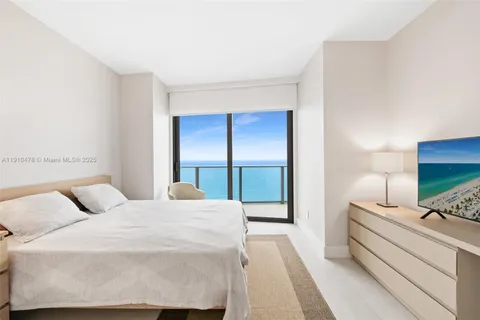 a bedroom with a bed and large window