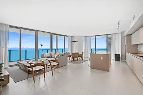 a view of a dining room with furniture and a window
