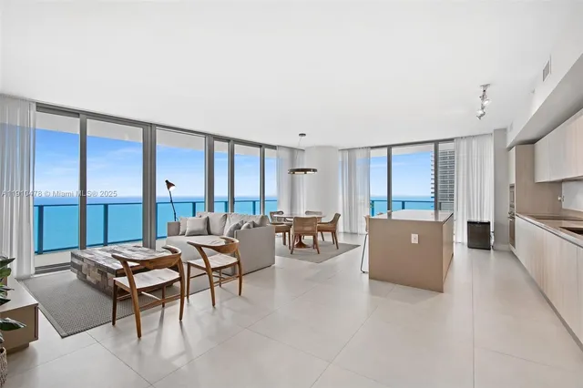 a view of a dining room with furniture and a window