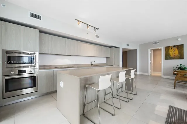 a large white kitchen with a large window