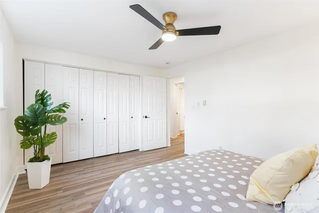 a bedroom with a bed and a potted plant