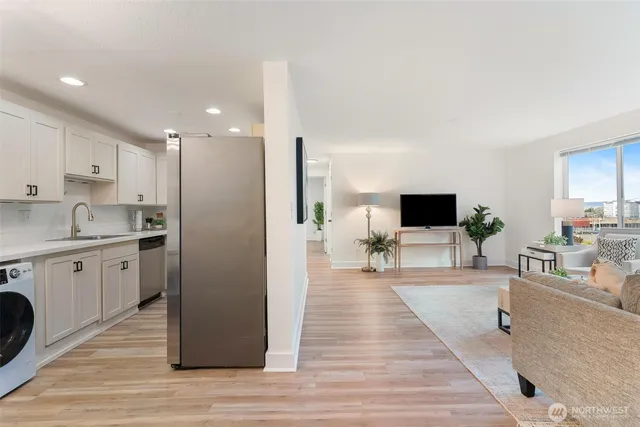 a spacious bedroom with a bed and a view of living room