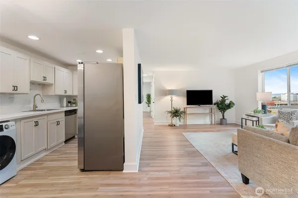 a spacious bedroom with a bed and a view of living room