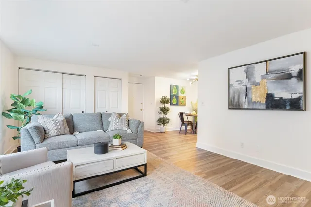 a living room with furniture and wooden floor