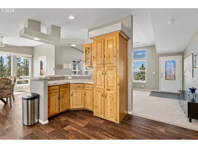 a kitchen with stainless steel appliances kitchen island granite countertop a refrigerator and a sink