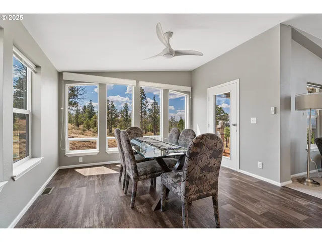 a dining room with furniture window and wooden floor