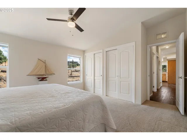 a bedroom with a large bed and a chandelier