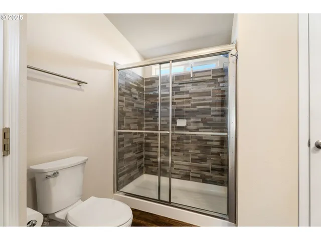 a bathroom with a shower and a toilet